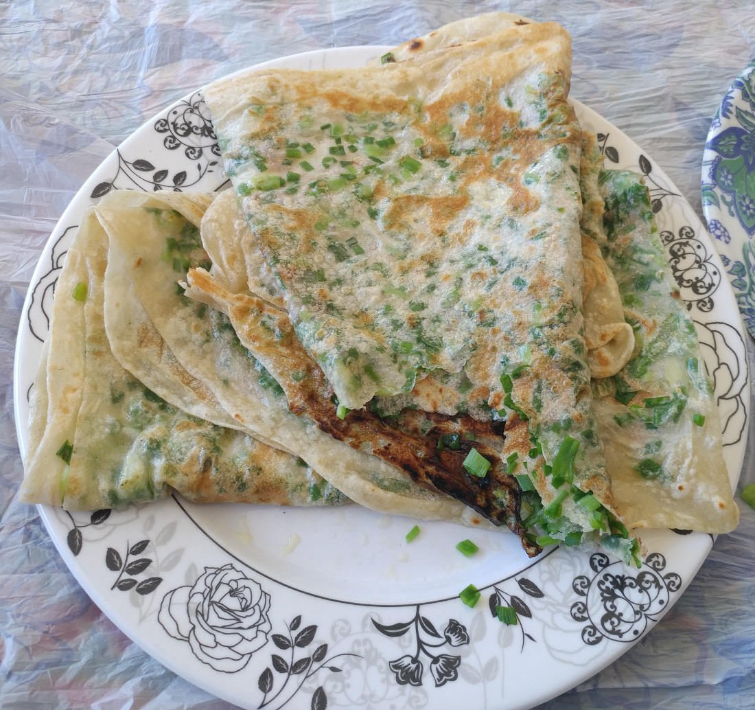Fresh Kurdish Kalaneh flatbread filled with green herbs